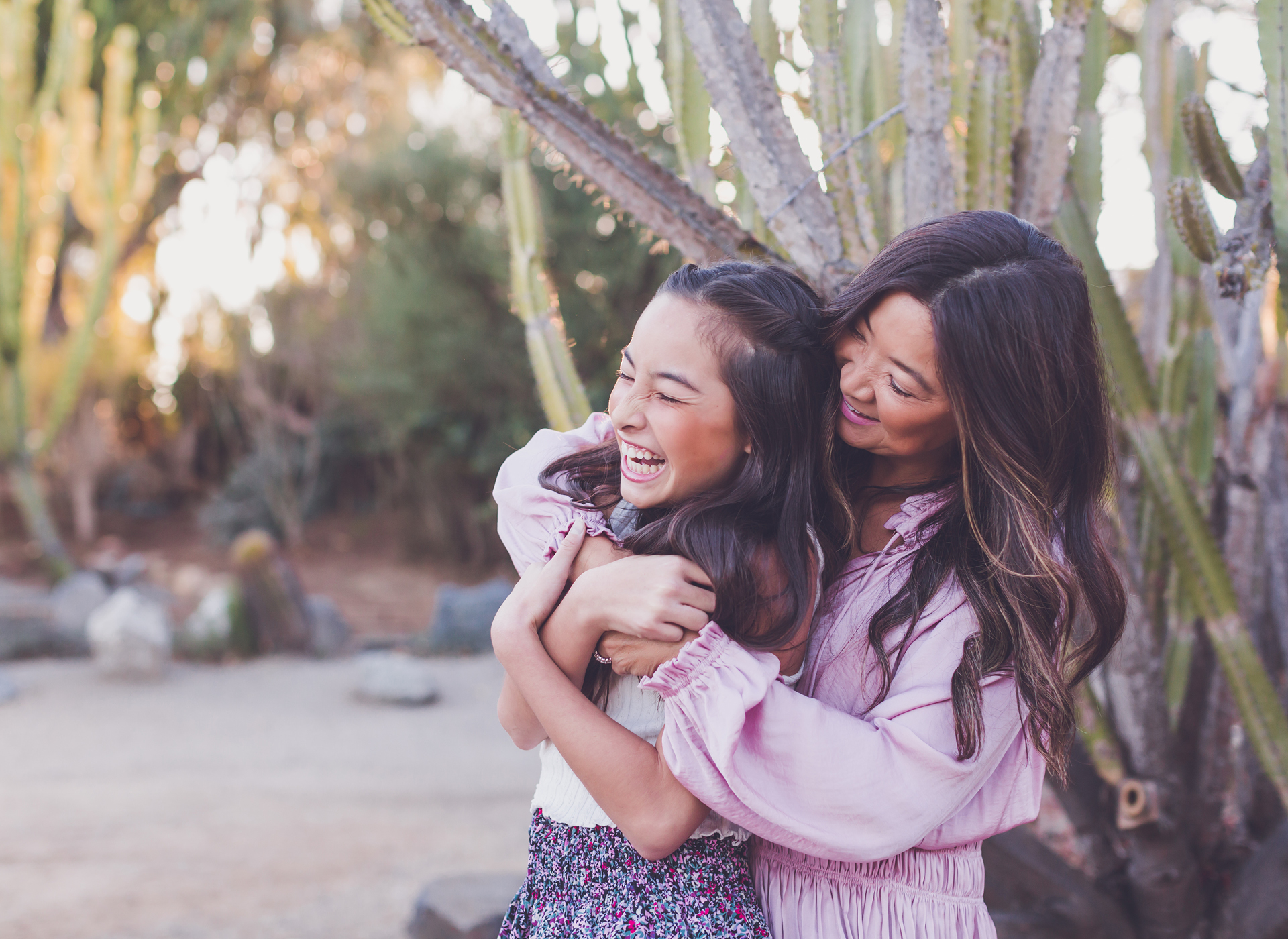 woman and young girl smile and hug