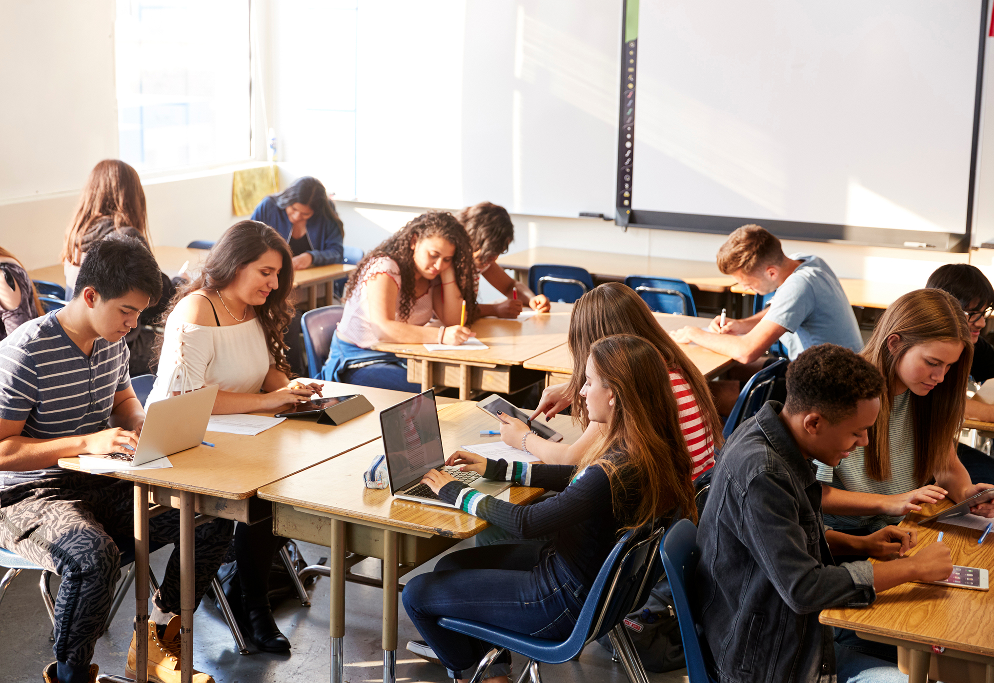 Teen using devices in classroom